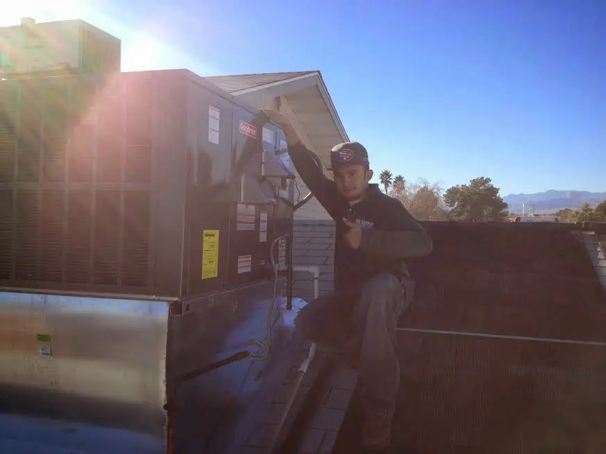 HVAC technician performing Air Duct Repair on a rooftop unit in Capitol View